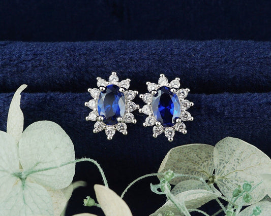 Pair of Halo Oval Sapphire Blue CZ Stud Earrings in Rhodium Plated over Sterling Silver