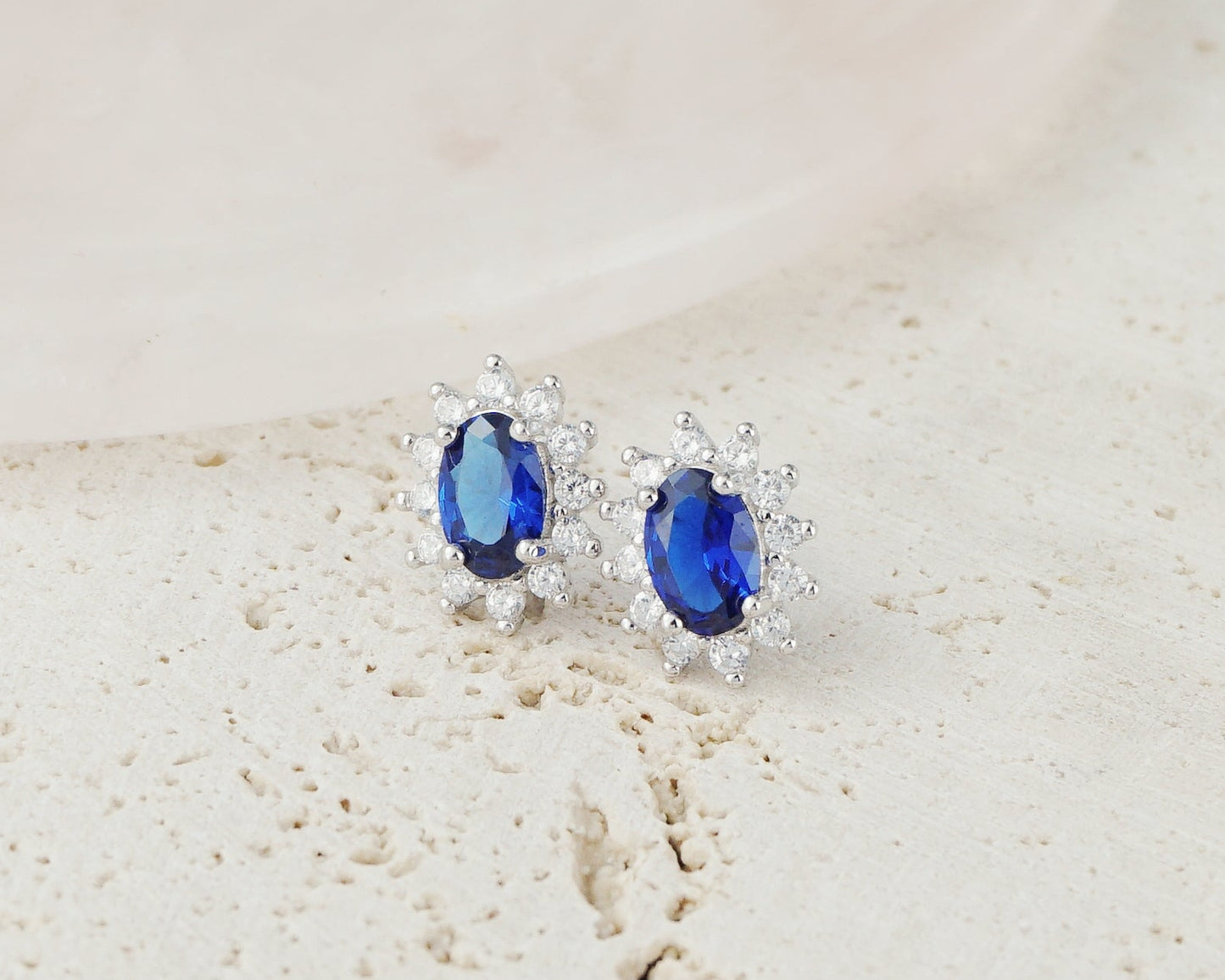 Pair of Halo Oval Sapphire Blue CZ Stud Earrings in Rhodium Plated over Sterling Silver
