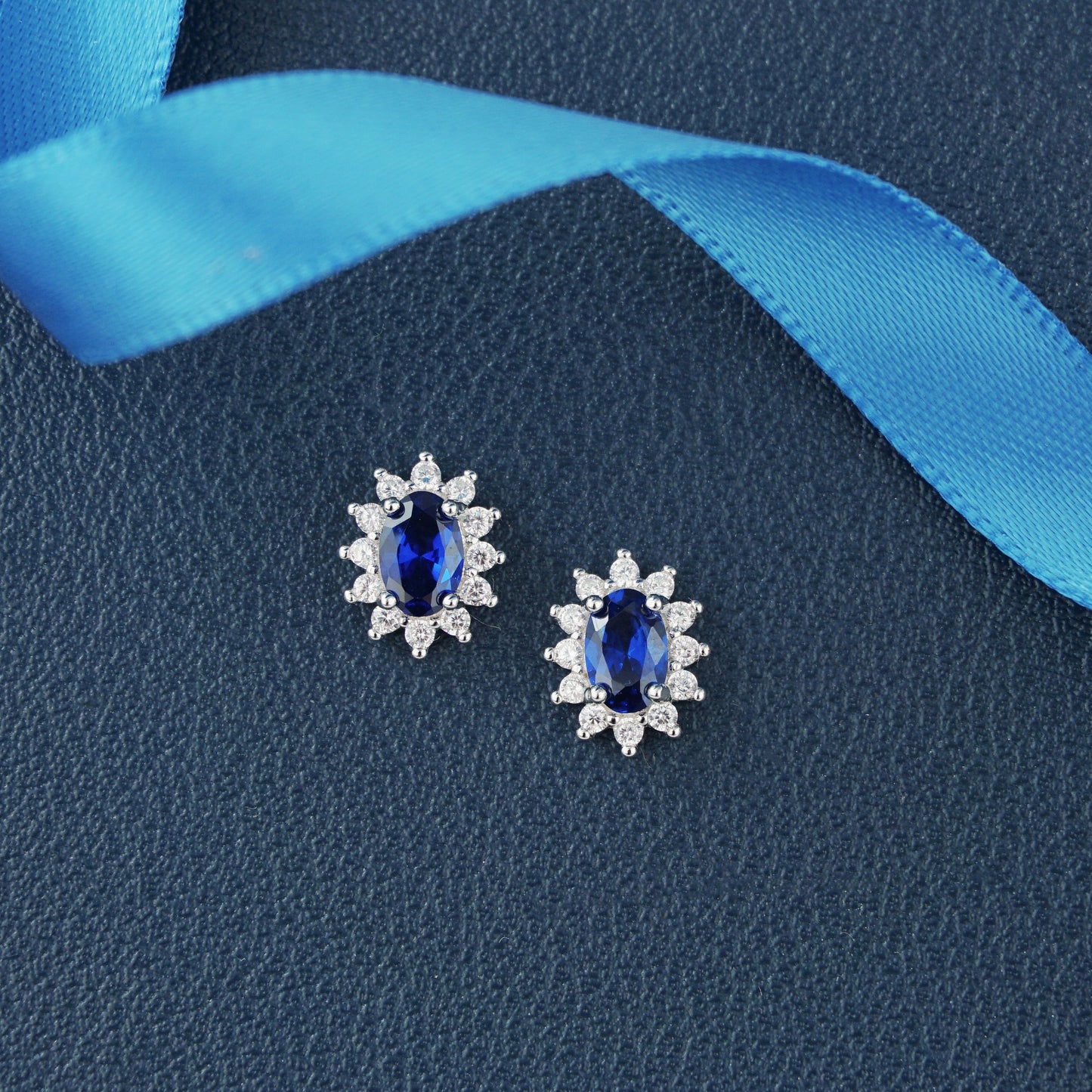 Pair of Halo Oval Sapphire Blue CZ Stud Earrings in Rhodium Plated over Sterling Silver