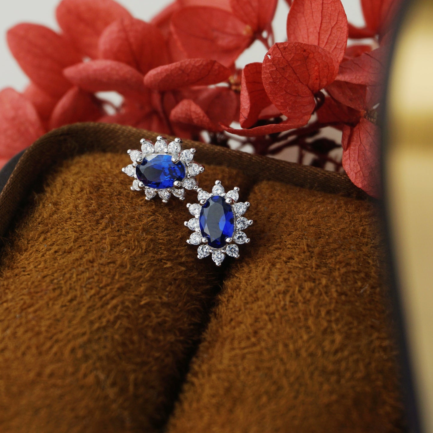 Pair of Halo Oval Sapphire Blue CZ Stud Earrings in Rhodium Plated over Sterling Silver