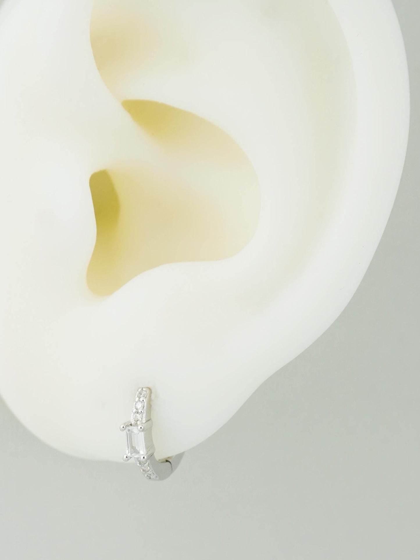 Pair of Paved Huggie Hoop Earrings in Sterling Silver or Plated Gold, Baguette CZ Stone